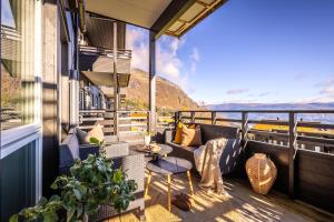 a balcony with furniture and a view of the mountains at Voss Resort self-service apartments in Skulestadmo