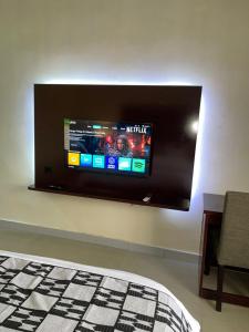 a flat screen tv hanging on a wall at Axari Hotel & Suites in Calabar