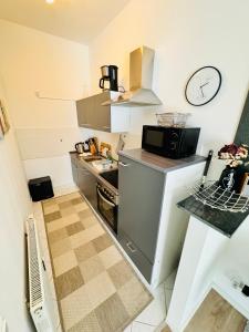 a small kitchen with a sink and a microwave at Ferienwohnung Jurga in Pirna