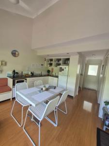 a kitchen with a table and chairs in a room at La Casita Preston Beach in Preston Beach