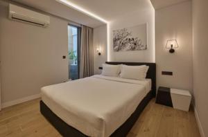 a bedroom with a large bed and a window at Teria Collection in Porto Heli