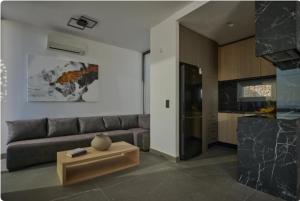 a living room with a couch and a coffee table at Teria Collection in Porto Heli