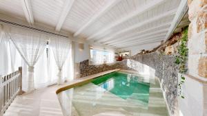 a swimming pool in the middle of a house at Masseria Torre Rossa in Fasano