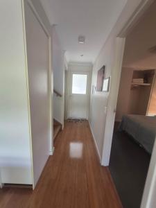 a hallway of a room with a bed and a window at La Casita Preston Beach in Preston Beach