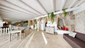 a living room with a table and a couch at Masseria Torre Rossa in Fasano