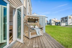 a person sitting in a chair on a porch at Tortuga in Olpenitz