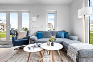 a living room with a couch and a table at Tortuga in Olpenitz