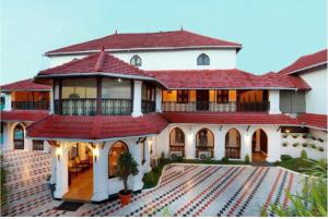 a large house with a red roof at The Heritage Kochi in Cochin
