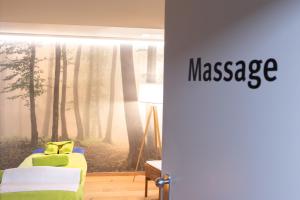a room with a bedroom with a tree mural at Hotel Alpenblick in Ohlstadt