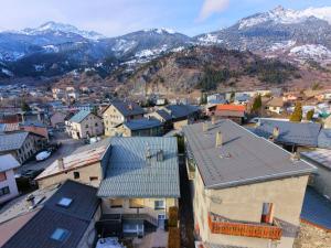 an aerial view of a town with snow covered mountains at Les Hauts du Pâquier in Modane +67 photos