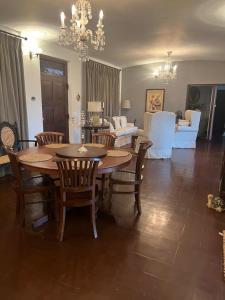 a dining room with a table and chairs and a living room at Kandy summerhill bungalow in Kandy