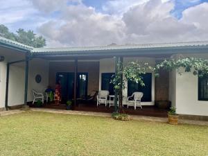 a home with a patio with chairs and a table at Kandy summerhill bungalow in Kandy