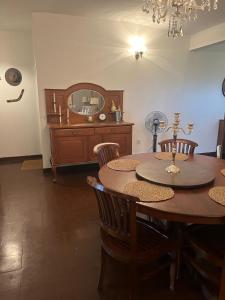 a dining room with a table and a mirror at Kandy summerhill bungalow in Kandy