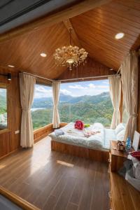 a bedroom with a bed and a large window at Xìu Homestay Tà Xùa in Bắc Yên +70 photos