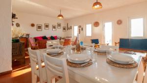 a dining room with a table and chairs at S'Archittu Sunset House in S'archittu Cuglieri