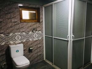 a bathroom with a toilet and a mirror at Villa viverra in Polonnaruwa