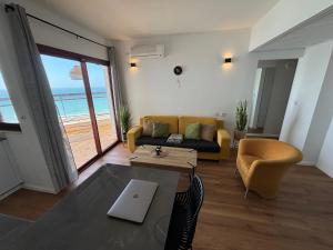 a living room with a couch and a table at Lev Yam Suite in Netanya