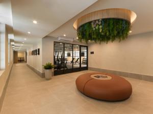 a lobby with a large circular table in the middle at The Initial Sama Serviced Residences in Singapore +42 photos