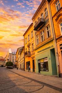 a group of buildings on a street at sunset at Apartament Komnata 8 in Przemyśl