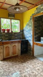 a kitchen with a stove and a stone wall at Wallace and Gromit's in Siquijor