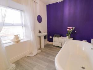 a bathroom with a white tub and a sink at San Antonio in Dungloe +25 photos