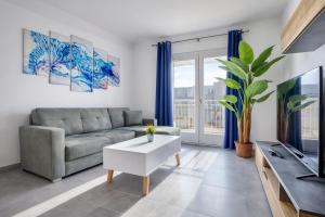 a living room with a couch and a tv at Modern 3-bedroom apartment Pieta in Tal-Pietà