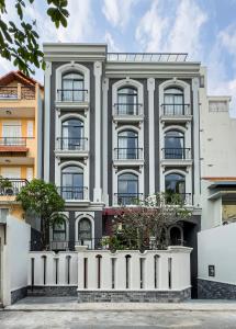 a gray building with a white fence in front of it at CityHouse TERA The S in Ho Chi Minh City