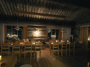 a dining room with wooden tables and chairs at KunnonKolo in Luosto