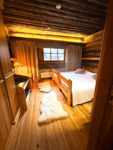 a bedroom with a bed in a log cabin at KunnonKolo in Luosto