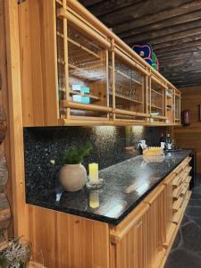 a kitchen with wooden cabinets and a black counter top at KunnonKolo in Luosto +34 photos