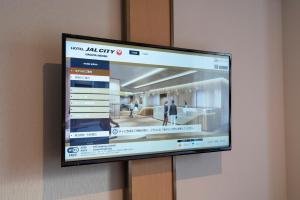 a flat screen tv hanging on a wall at Hotel JAL City Nagoya Nishiki in Nagoya
