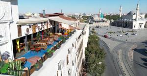 a building with tables and chairs on the side of a street at THINK HOTEL in Konya