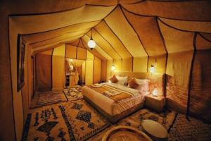 a room with a bed inside of a tent at Jumeria Grand Luxury Desert Resort & Camp in Jaisalmer