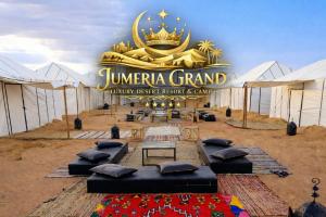 a marquee with a bunch of beds in front of a sign at Jumeria Grand Luxury Desert Resort & Camp in Jaisalmer