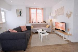 a living room with a couch and a table at Escapade de Pierrefonds - maison T4 vue château in Pierrefonds +36 photos