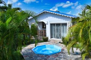 a house with a blue tub in front of it at Cottage Vanda in Le Moule