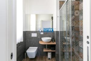 a bathroom with a sink and a toilet at Condominio Medusa in Lido di Jesolo +119 photos