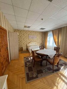 a room with a bed and a table and chairs at Ametist in Mukacheve +31 photos