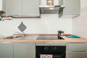 a kitchen with a sink and a stove at Bigattera Apartments in Varese +47 photos