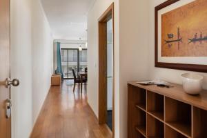 a hallway leading to a living room with a table at Camélia's Apartment I by An Island Apart, Lda in Funchal +7 photos