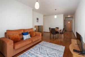 a living room with a couch and a dining room at Camélia's Apartment I by An Island Apart, Lda in Funchal