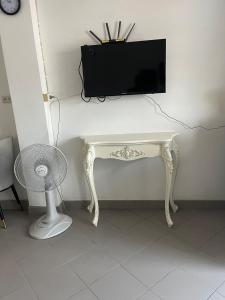 a white desk with a television on top of it at Niruan apartment in Pattaya