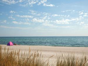 a pink tent sitting on a beach next to the ocean at 6 person holiday home in Væggerløse in Bøtø By
