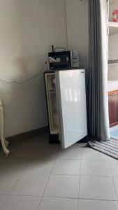 a small refrigerator sitting on the floor in a room at Niruan apartment in Pattaya
