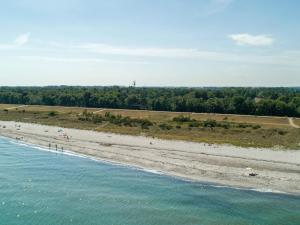 an aerial view of a beach with people on it at 6 person holiday home in Væggerløse in Bøtø By