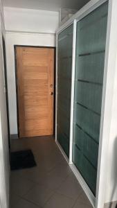 a door leading to a room with a tiled floor and a hallway with at Niruan apartment in Pattaya +3 photos