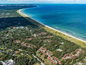 an aerial view of a beach with houses and the ocean at 6 person holiday home in Væggerløse in Bøtø By +108 photos