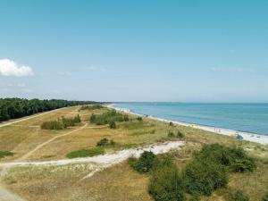 an aerial view of a beach with people on it at 6 person holiday home in Væggerløse in Bøtø By