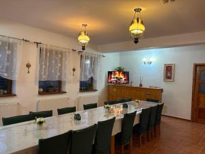 a conference room with a large table and chairs at Vila dintre Brazi in Moieciu de Jos