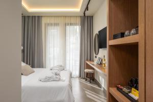 a hotel room with a bed and a window at Monarco Executive Rooms in Rhodes Town